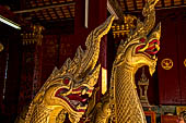 Wat Xieng Thong temple in Luang Prabang, Laos. Detail of flame-like gilded lacquered carvings of sacred serpents or nagas on the Royal Funerary Chariot. 